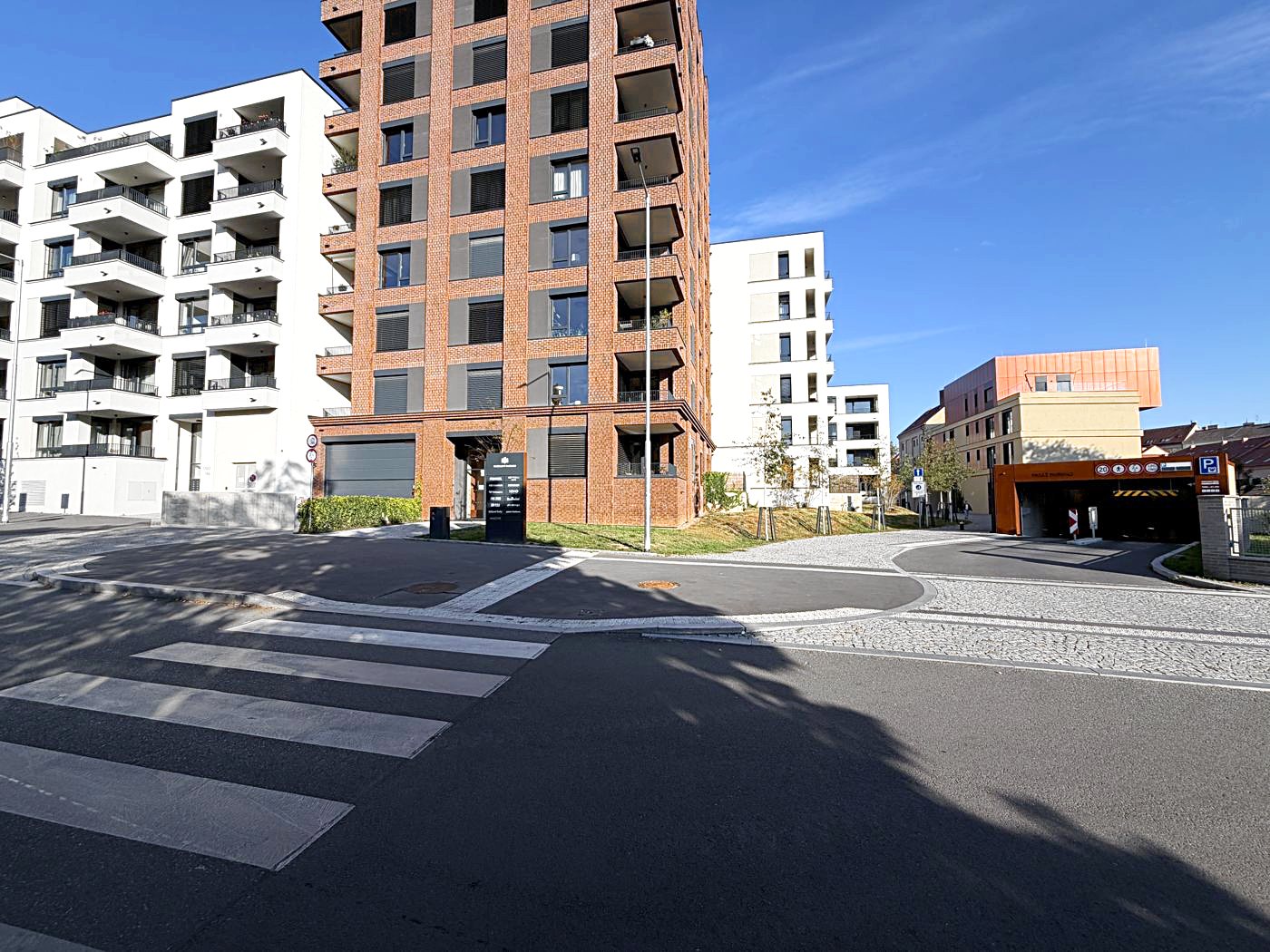 Go back to your car. The garage entrance is on Závišova street – the door in the