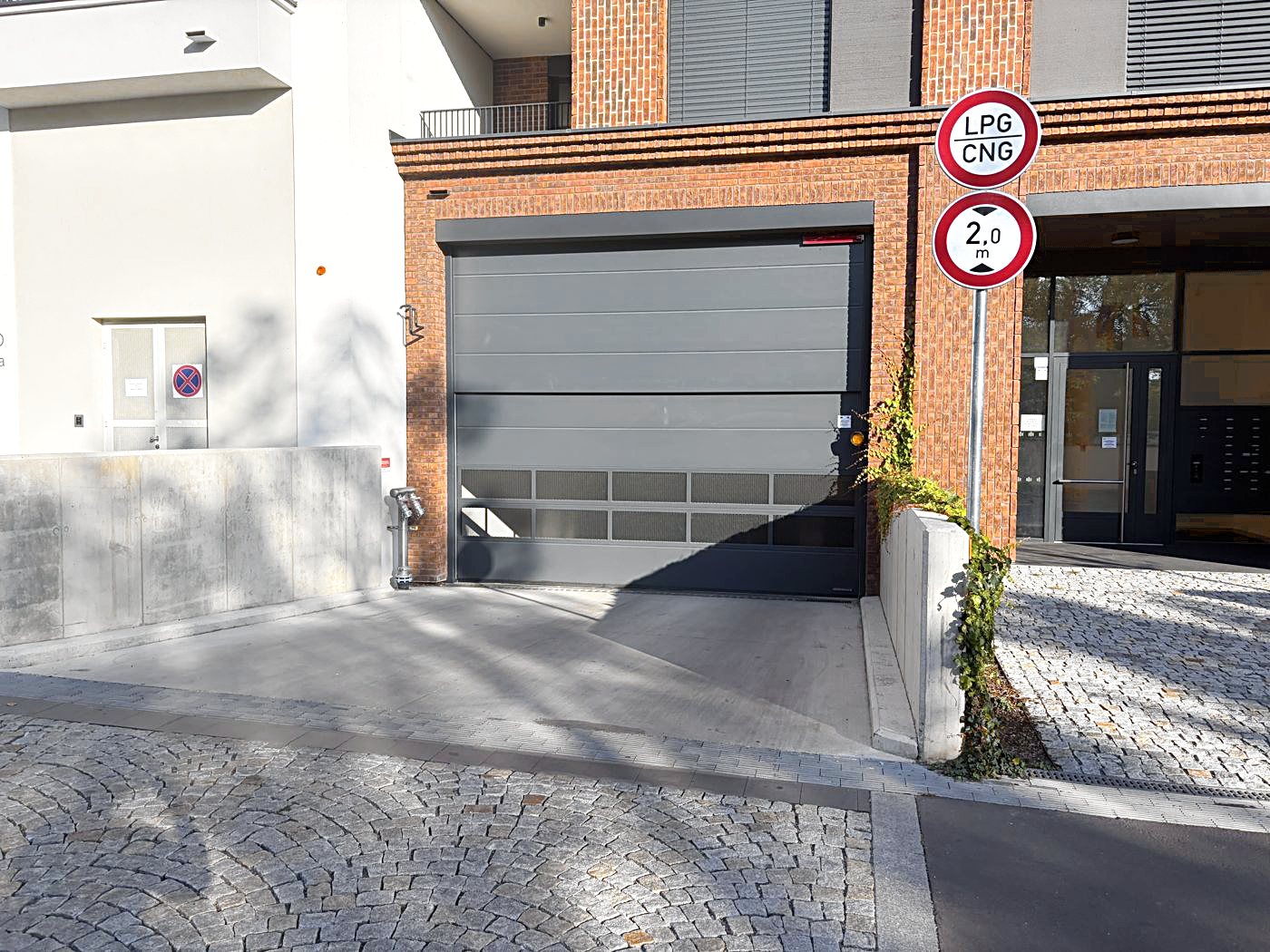 Go back to your car. The garage entrance is on Závišova street – the door in the