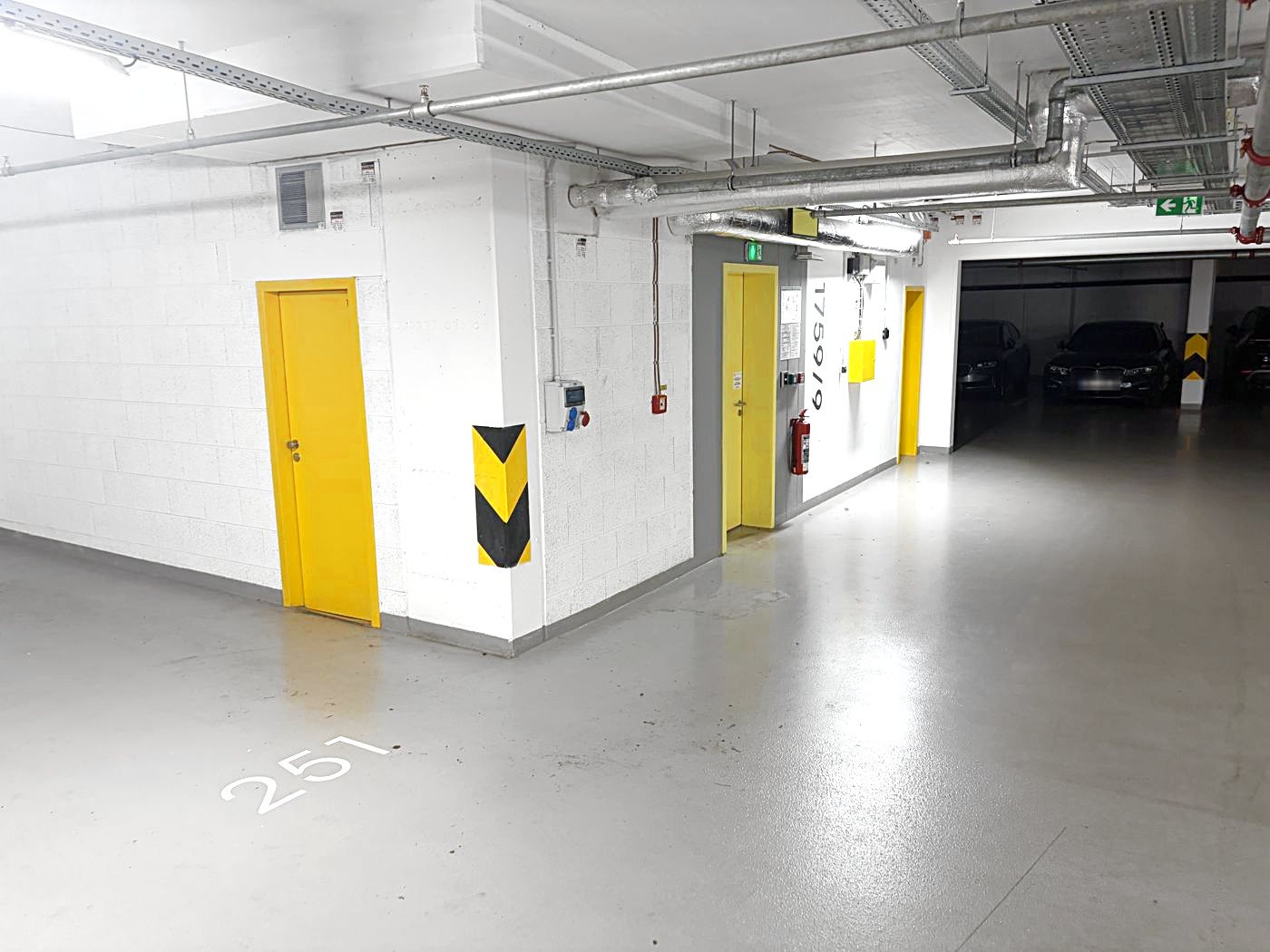 Pedestrian exit: with your back to the car, walk left to the yellow door marked