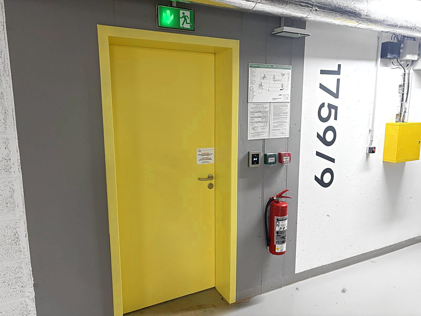 Pedestrian exit: with your back to the car, walk left to the yellow door marked