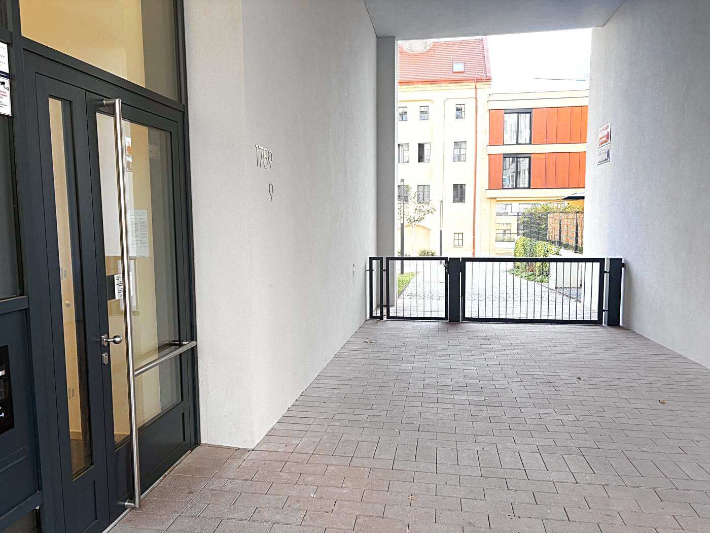 You come out through the entrance Mužíkova 1759/9. Turn left through the passage