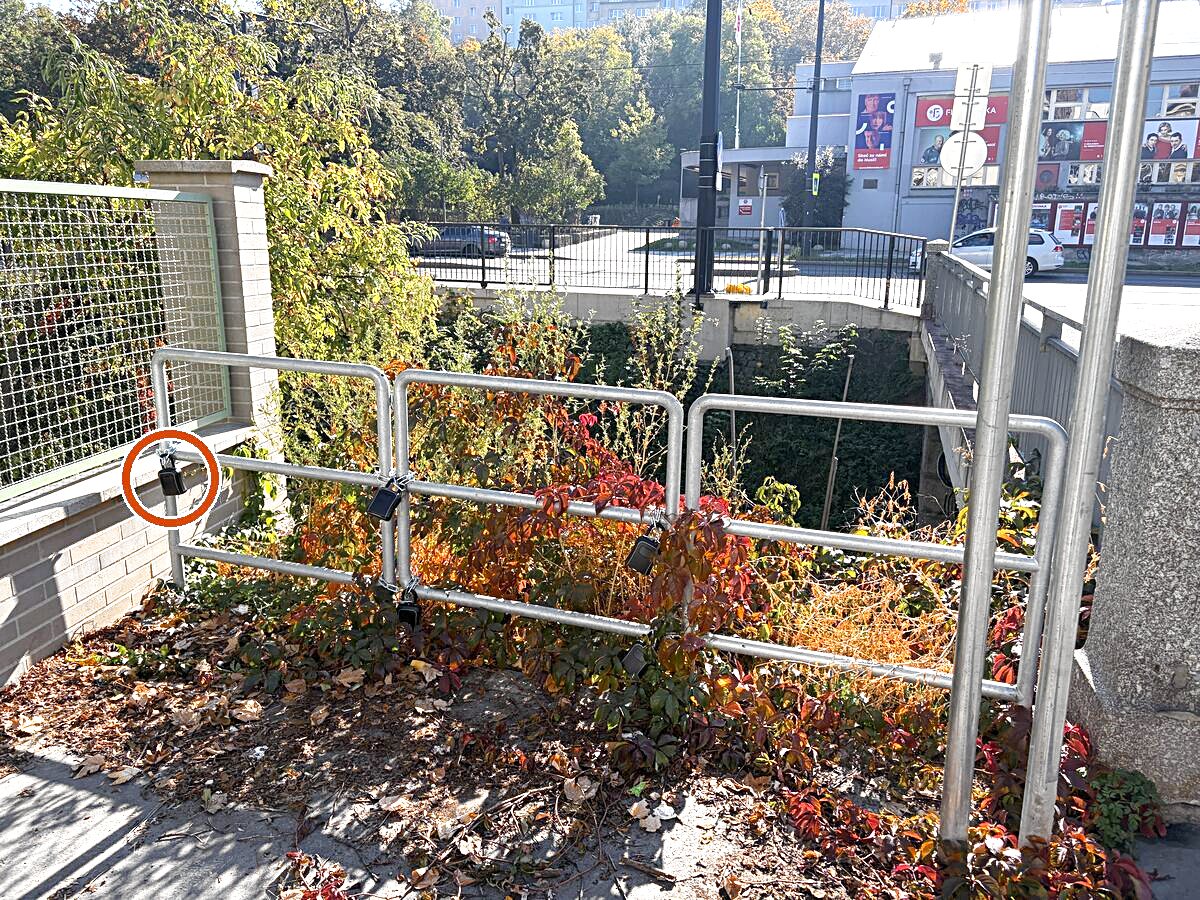 Right after the bridge, on your right in the corner by the green fence, there is